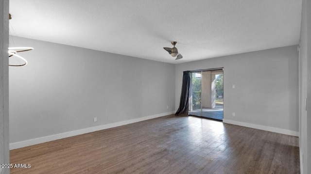 unfurnished room with dark wood-type flooring