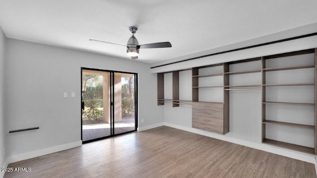 unfurnished bedroom featuring access to exterior, ceiling fan, a closet, and light wood-type flooring