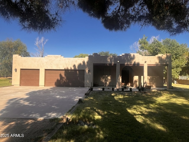 25722 S 179th St, Queen Creek, AZ 85142 - pueblo revival-style home featuring driveway, stucco siding, a front yard, and an attached garage