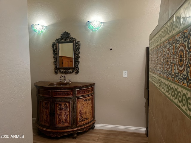 25722 S 179th St, Queen Creek, AZ 85142 - hallway featuring a sink, wood finished floors, and baseboards