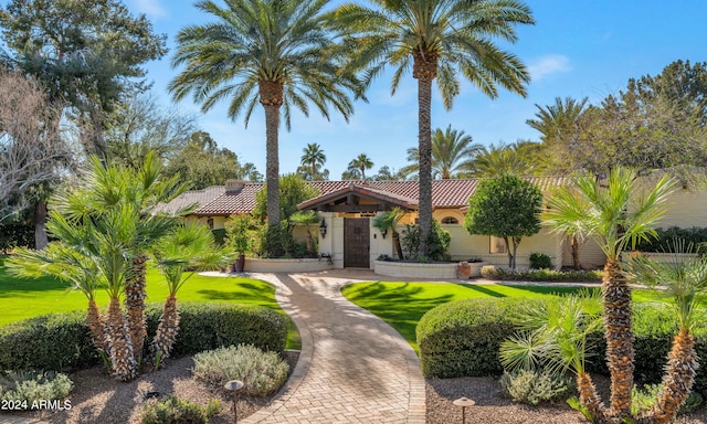 mediterranean / spanish house with a front yard