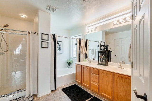 bathroom featuring vanity and independent shower and bath