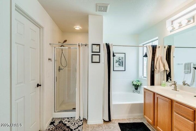 bathroom featuring tile patterned floors, vanity, and separate shower and tub