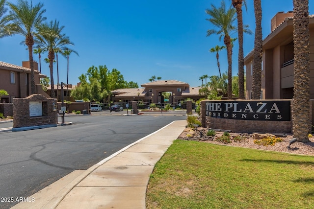 view of road featuring a gated entry and curbs