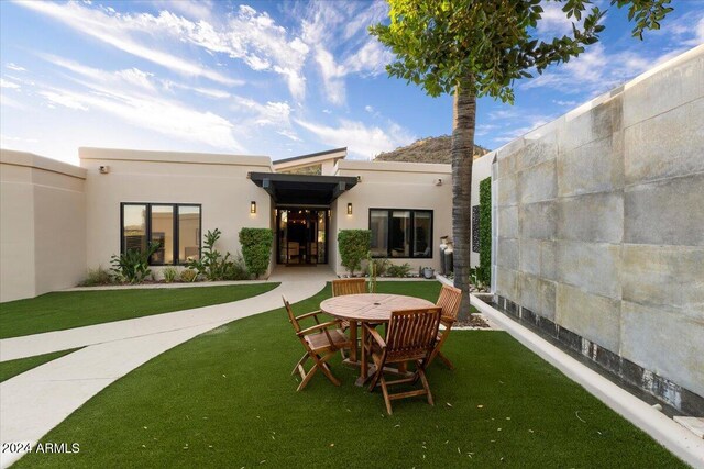 rear view of house with a lawn