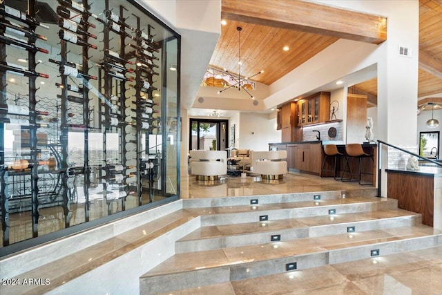 interior space with beam ceiling, wood ceiling, and a high ceiling