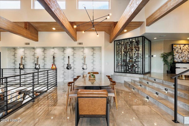 wine room featuring a notable chandelier, a high ceiling, and beamed ceiling