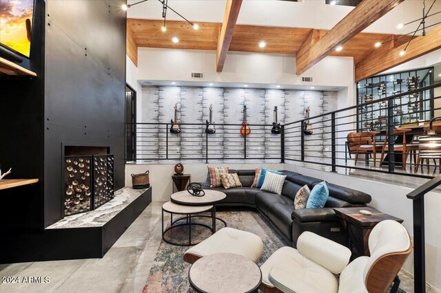 living room featuring wood ceiling, beam ceiling, and a high ceiling