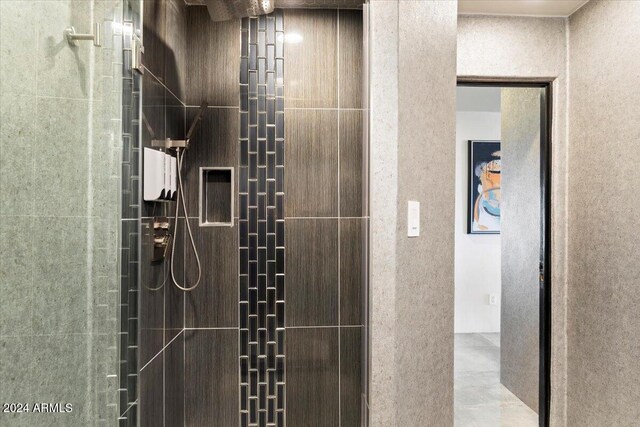 bathroom with a tile shower