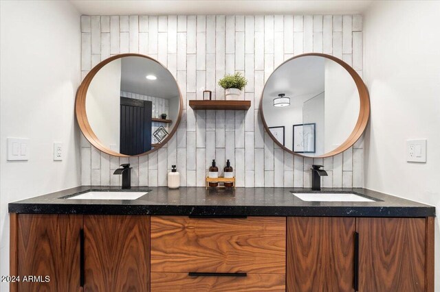 bathroom with vanity and tasteful backsplash