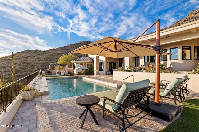 view of pool with a patio area and a mountain view