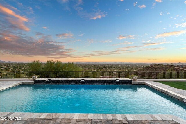 view of pool at dusk