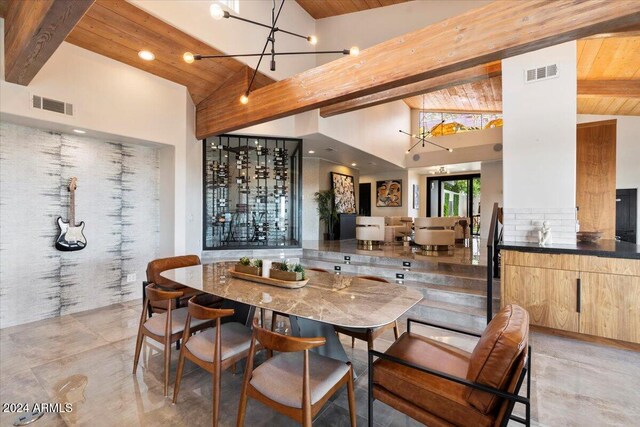 dining room featuring beam ceiling, high vaulted ceiling, and wooden ceiling