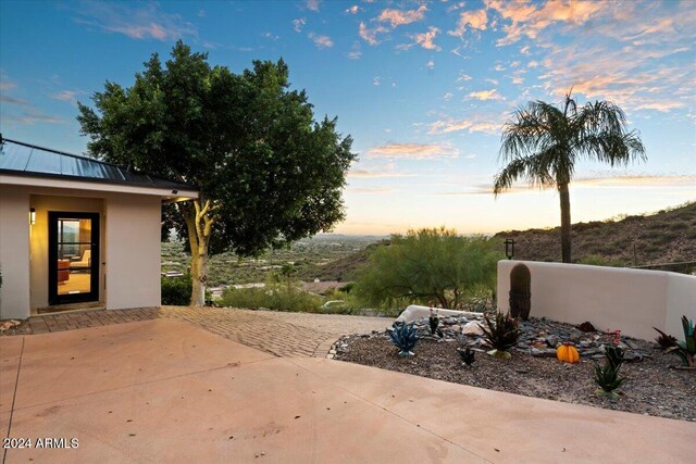 view of patio terrace at dusk