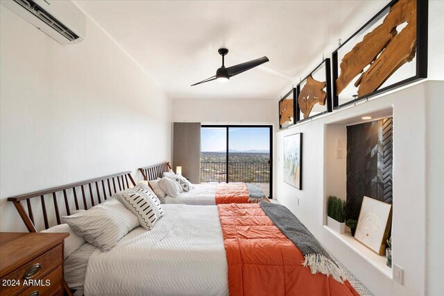 bedroom featuring ceiling fan, access to outside, and an AC wall unit