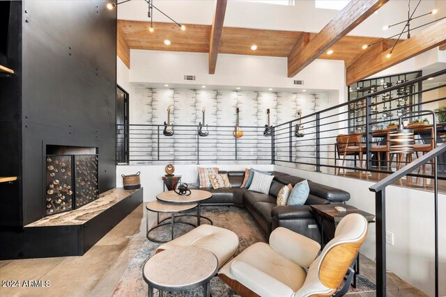 living room with a high ceiling and beam ceiling