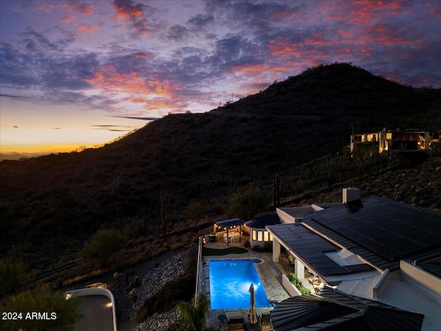 view of pool at dusk