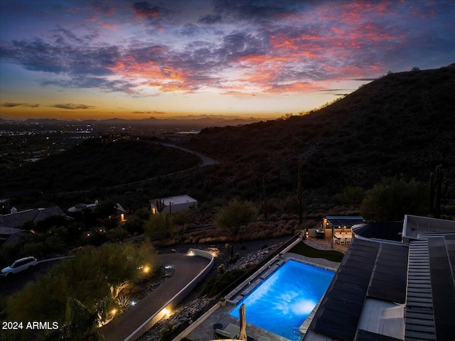 view of pool at dusk