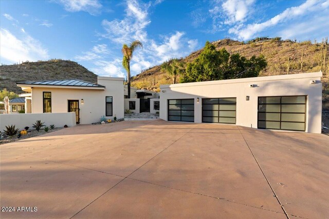 modern home featuring a garage and a mountain view