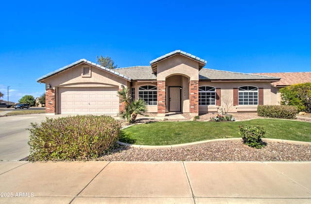 single story home with stucco siding, a front lawn, concrete driveway, a garage, and brick siding