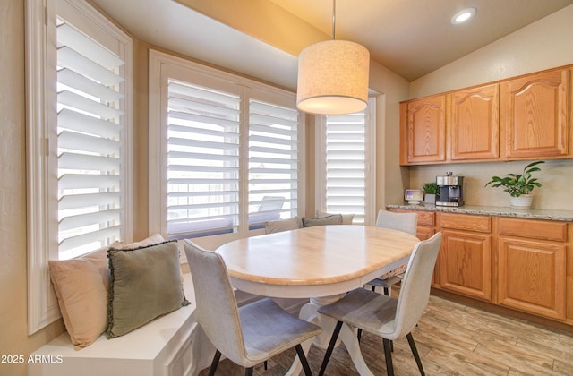 dining space with recessed lighting, light wood-style flooring, and vaulted ceiling