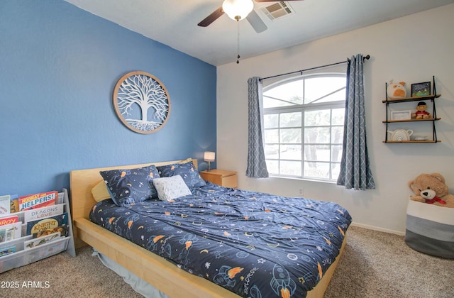 carpeted bedroom with visible vents, baseboards, and a ceiling fan