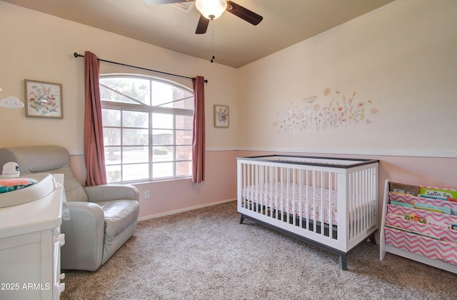 bedroom with a nursery area, carpet, and a ceiling fan