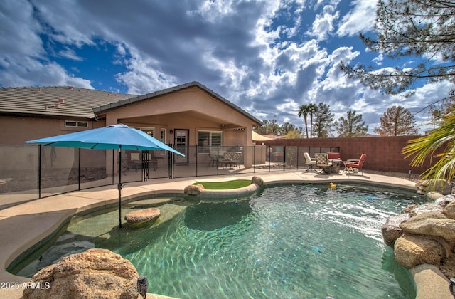 view of swimming pool featuring a fenced in pool, a patio, and fence