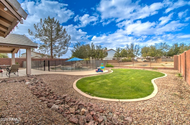 view of yard featuring a patio area and a fenced backyard