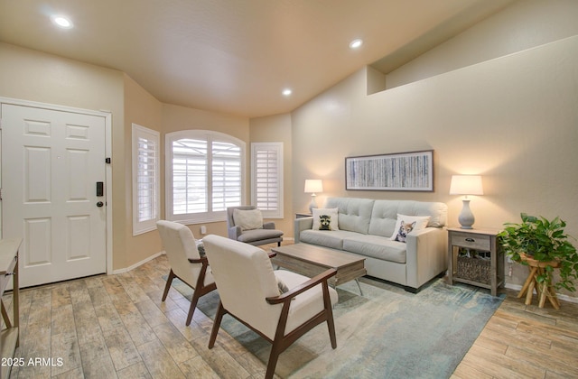 living area with light wood finished floors, recessed lighting, and baseboards