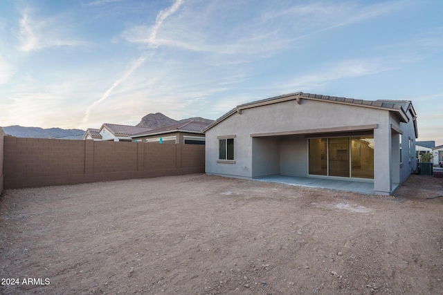 rear view of property featuring central AC unit and a patio area