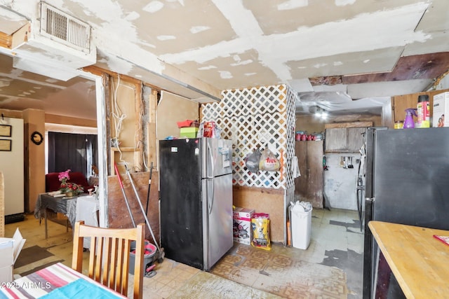 kitchen featuring freestanding refrigerator and visible vents