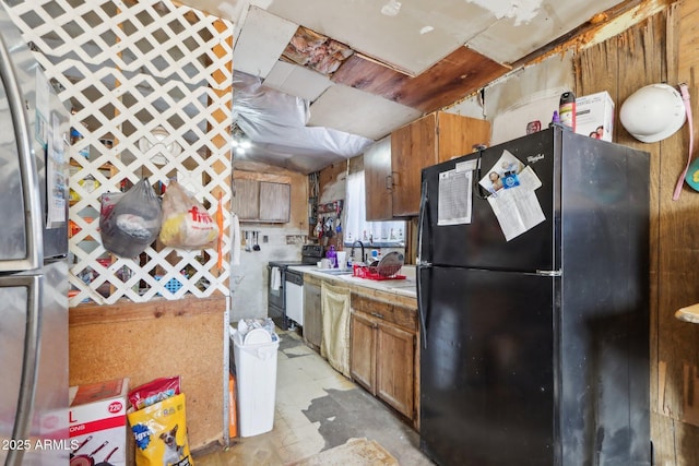 kitchen with a sink, black appliances, brown cabinets, and light countertops