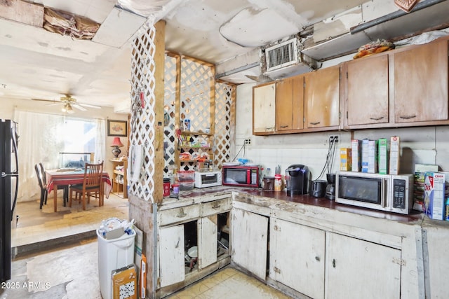 kitchen with freestanding refrigerator, a toaster, stainless steel microwave, and ceiling fan