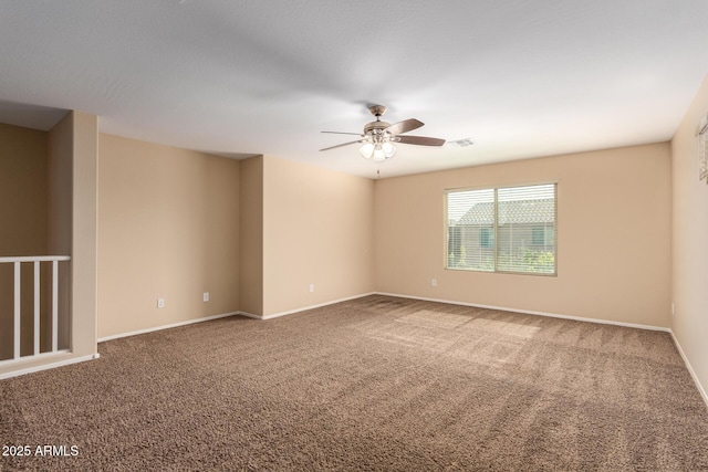 carpeted spare room featuring ceiling fan