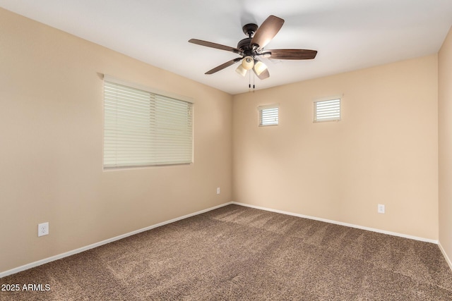 carpeted spare room with ceiling fan