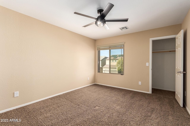 unfurnished bedroom featuring ceiling fan, a closet, and carpet