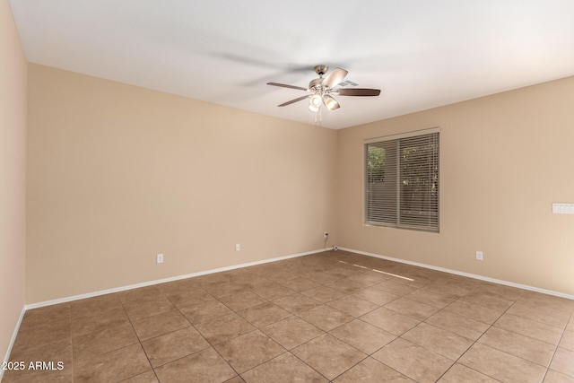 tiled spare room featuring ceiling fan