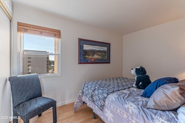 bedroom featuring baseboards and wood finished floors