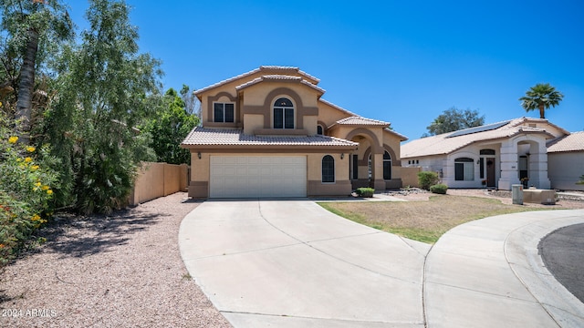 mediterranean / spanish-style home with a garage