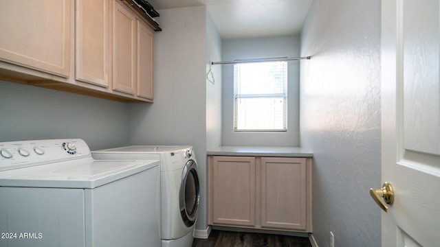 clothes washing area featuring cabinets, dark hardwood / wood-style floors, and washing machine and clothes dryer