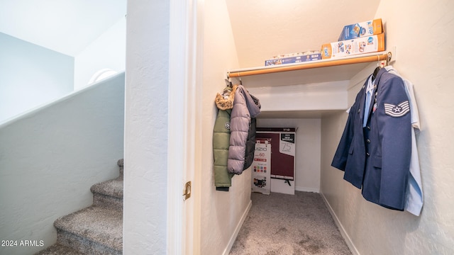 interior space with vaulted ceiling and carpet