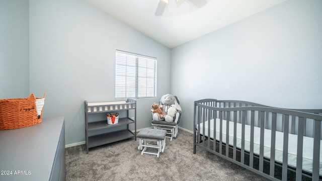 bedroom featuring carpet flooring, vaulted ceiling, a nursery area, and ceiling fan