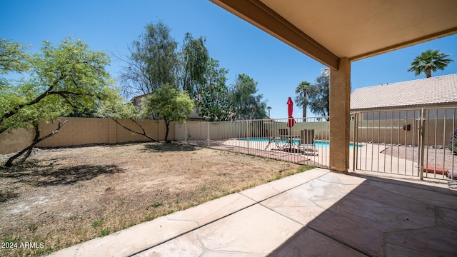 view of yard featuring a patio and a fenced in pool