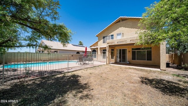 back of house with a patio and a fenced in pool