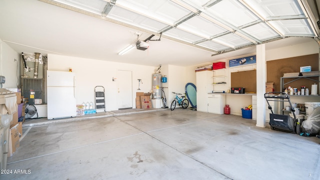 garage with a garage door opener, gas water heater, and white refrigerator