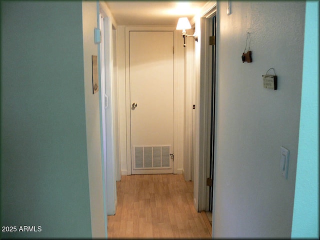 corridor with light hardwood / wood-style floors