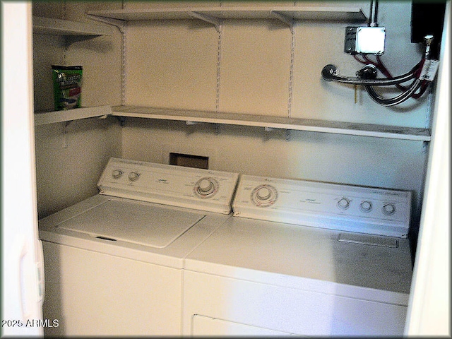 laundry room with washing machine and clothes dryer