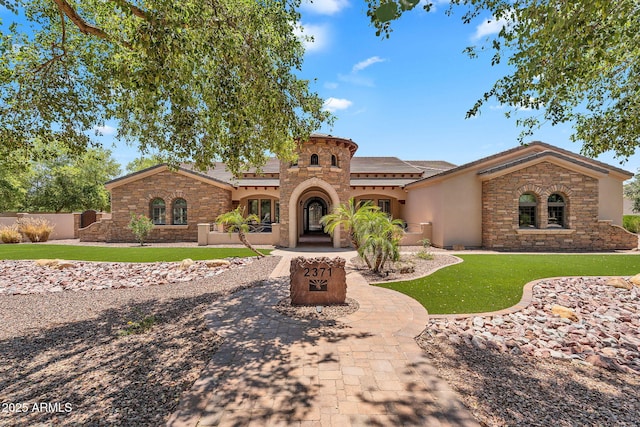 2371 E Sanoque Ct, Gilbert, AZ 85298 - mediterranean / spanish house with stone siding, stucco siding, and a front lawn