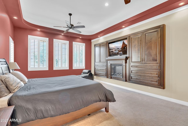 2371 E Sanoque Ct, Gilbert, AZ 85298 - carpeted bedroom with a glass covered fireplace, recessed lighting, a raised ceiling, and ceiling fan